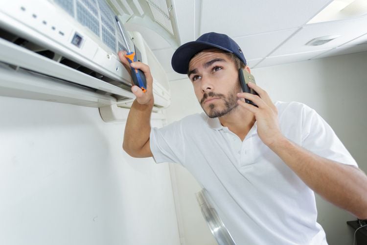 Technician Checking The Airconditioning Unit