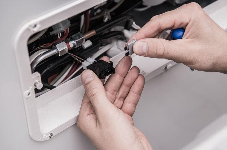 Technician Fixing A Fuse